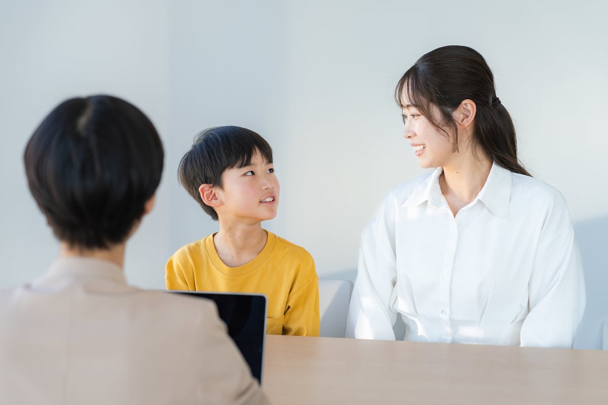 A Lighthouse staff member warmly welcoming and speaking with a prospective family